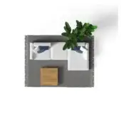 Beige sectional sofa with blue pillows, light wood side table, green plant, and gray fringed rug in studio setting.