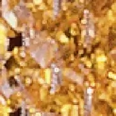 Amber and gold granular texture with mottled dark brown and black markings, displaying a warm, muted, and distressed visual composition.