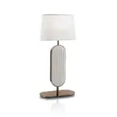Elegant DV Home Collection Coco lamp with quilted light gold metal and a white fabric shade supported by a reflective base