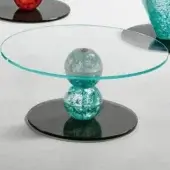 alice bassa coffee table, turquoise glass base, clear circular top, black platform, studio lighting, modern design.