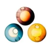 Glass spheres in burgundy, blue, and amber showcase contrasting inner colors and circular cutouts against a white backdrop.