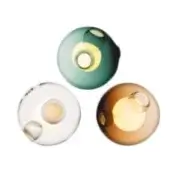 Wall-mounted spherical lights, teal, amber, transparent glass, concentric circle designs, studio shot, minimalist modern lighting.