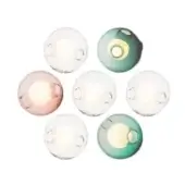 Wall sconces, clear & teal glass, spherical form arranged in a circle, warm white light, cylindrical metal bases, white background.