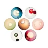 Translucent glass spheres in teal, white, yellow-green, tan, pink, and purple-red are arranged circularly, featuring core openings and textural variations.