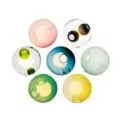 Glass spheres in pale pink, clear, green, blue, and yellow arranged in a circular pattern against a white backdrop, featuring circular openings.