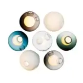 Spherical wall lights in smoky brown, white, teal, sage, gray tones, featuring translucent blown-glass with illuminated circular openings.