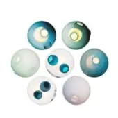 Glass beads in teal, green, and blue tones display translucent spheres within matte finishes, arranged on a white background.