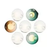 Spherical wall lights with clear glass globes, featuring circular cutouts and warm LED bulbs, arranged in a circular pattern against a white wall.
