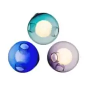 Spherical wall lights, translucent glass, teal, cobalt, lavender shades; recessed circular openings, warm glowing light, glossy finish.
