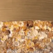 Amber faceted mosaic texture with rounded elements, above a gradient band of beige and tan tones, diffused lighting.