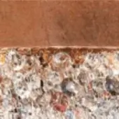 Glass bead mosaic texture with clear and dark spheres, reddish accents, under a warm brown matte band, diffused lighting.