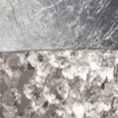 Crystalline texture, light gray to brown tones, dense mosaic pattern with striated upper section and diffused lighting.
