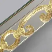 Gold resin swirls and reflective silver glass with dark green border, ornate detail from mirror frame or architectural element.