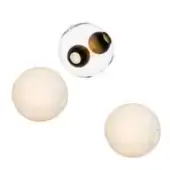 Glass spheres with concentric brown and black interiors, flanked by matte off-white spheres with circular openings, on a white background.