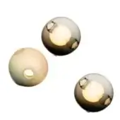 Spherical light fixtures, smoked gray and translucent beige glass, feature warm white illumination and circular cutouts, minimalist modern design.