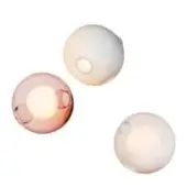 Spherical wall lights, translucent glass, staggered arrangement, pink, white, circular openings, minimalist design, neutral backdrop.