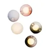 Spherical wall lights in smoky gray, pale pink, white, amber & rose hues feature circular openings and textured surfaces with diffused illumination.