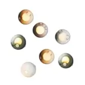 Wall sconces, glass globes, amber and green hues, circular arrangement, dark metal mounting, warm light, organic texture, studio lighting.