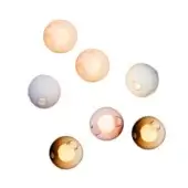 Spherical wall lights in amber, peach, rose, and white tones display translucent shades and circular bulb openings against a white backdrop.