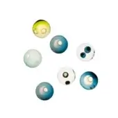 Glass orbs, translucent white and colored, arranged in a composition with circular inclusions against a white backdrop.