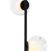 Wall-mounted light fixture, matte black metal, with two clear glass globes emitting warm light, minimalist geometric design.