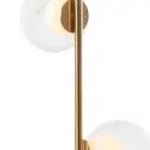 Wall sconce, brushed brass finish, with two clear glass globes on a vertical rod, emitting warm light against a white wall.