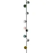 Hand-blown glass orbs in varying sizes and translucent colors—green, pink, yellow, blue—hang vertically on a dark wire against white.