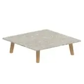 Speckled gray planar surface with visible inclusions rests on four light-toned cylindrical legs in a symmetrical arrangement