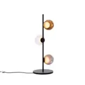 Table lamp, black metal, with three spherical glass shades—amber, clear ripple, pale purple—suspended on a slender stem and circular base.