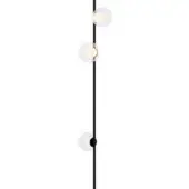 Floor lamp, matte black metal, slender pole with three clear glass spherical shades emitting warm yellow light, circular base.