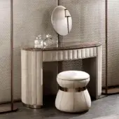 Elegant DV Home Collection Vogue vanity with light cream leather and glossy lacquered wood, showcasing quilted finish and shining steel mirror kit