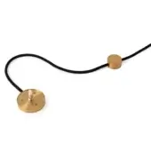 Table lamp cord with black textile cable, brass cylindrical beads, and circular base featuring a brass toggle switch.
