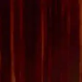 Burgundy velvet fabric with vertical ribbing, dense pile texture, and soft diffused lighting displaying rich tonal variations.