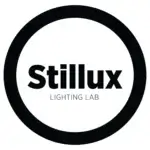 Stillux Lighting Lab logo, black text in a white circle, minimalist design, sans-serif typography, circular composition, monochrome palette.