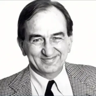 Marco Zanuso portrait, black and white photograph, man in checkered blazer, light shirt, navy tie, formal studio lighting, neutral expression.