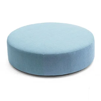 Velvet pouf, light blue, cylindrical shape with a flattened top, matte fabric texture, centered on a white background, soft shadows.