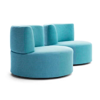 Modular lounge chair, turquoise corduroy fabric, rounded dual-section design with stacked cushions and circular seat, studio shot.
