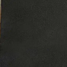 Dark gray synthetic texture with embossed granular surface, resembling distressed leather; matte finish, raw edges, “formitalia” text visible.