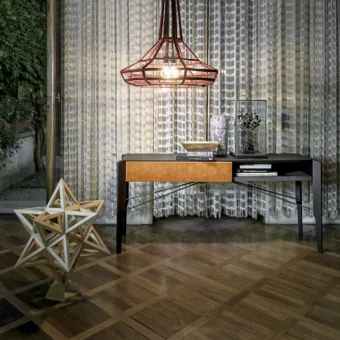 Sophisticated Arketipo Glory console built with a dark gray frame, streamlined metal supports, and a single orange Leonardo leather drawer