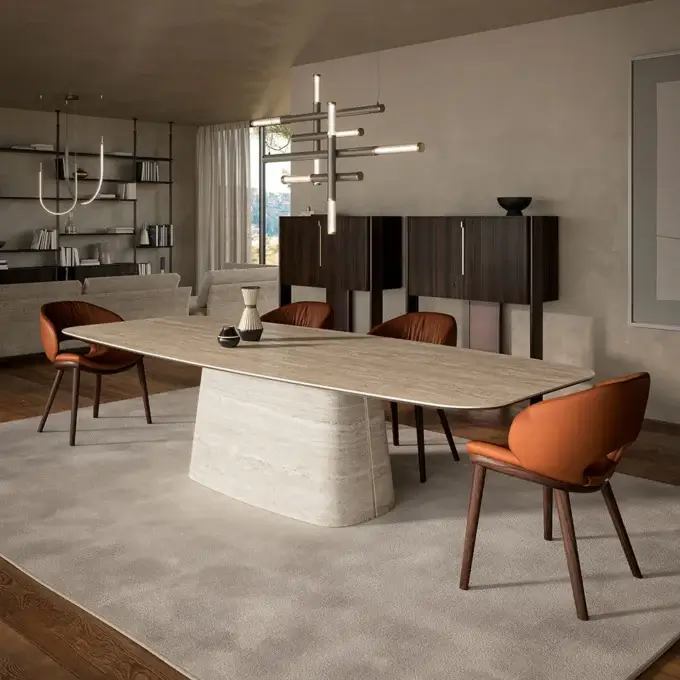 Dining room with marble table, leather chairs, dark wood sideboard, modern chandelier, gray sofa, artwork, wood flooring, and mountain view.