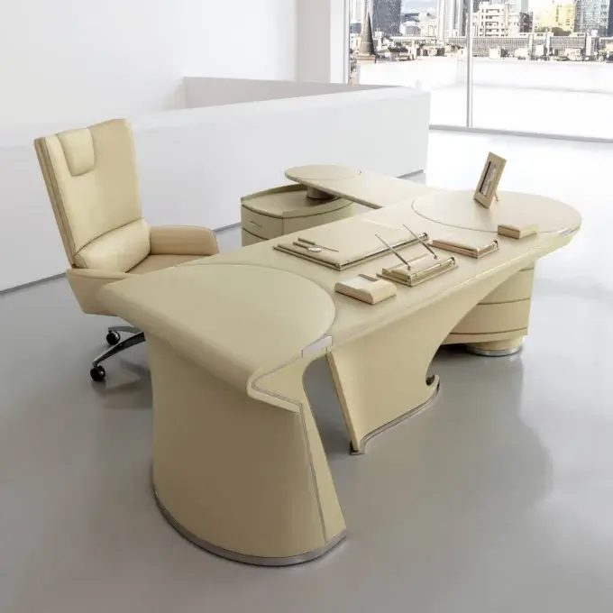 Cassoni Mascheroni executive desk, beige leather upholstery, curved shape with integrated pen trays, paired with circular accent table.