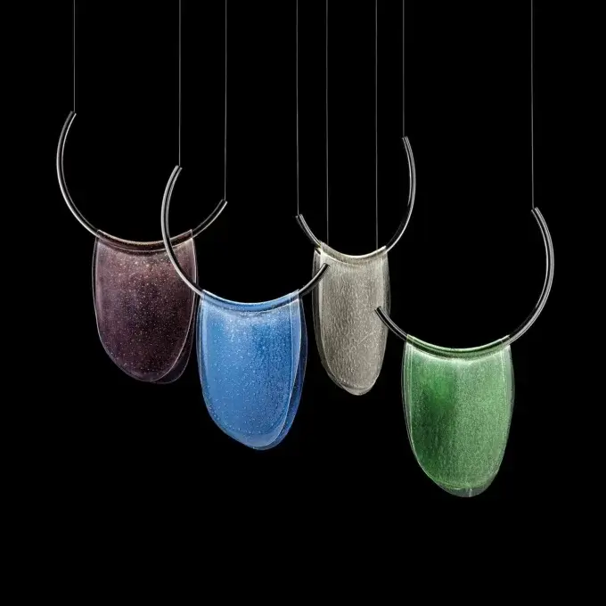 Teardrop pendant lights, colored glass shades, chrome crescent frames, black cords, speckled, marbled, granular, moss-like textures.