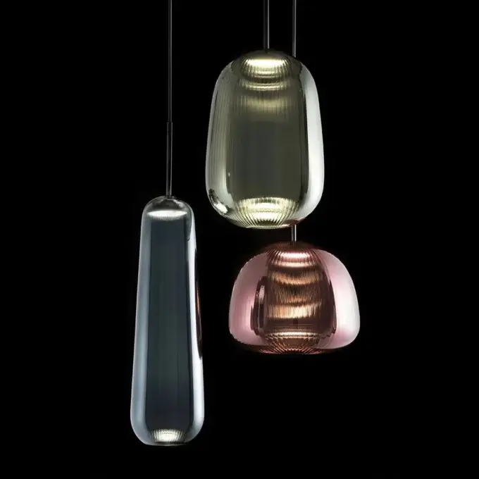Pendant lights, glass and ribbed texture, teardrop, rounded, olive-green, pink tones, warm glow, black background, Melogranoblu Cassoni.