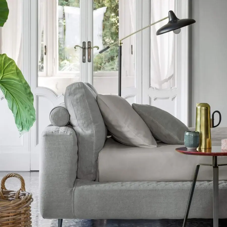 Distinctive Bonaldo Owen bed with muted gray textile upholstery and dark painted metal feet