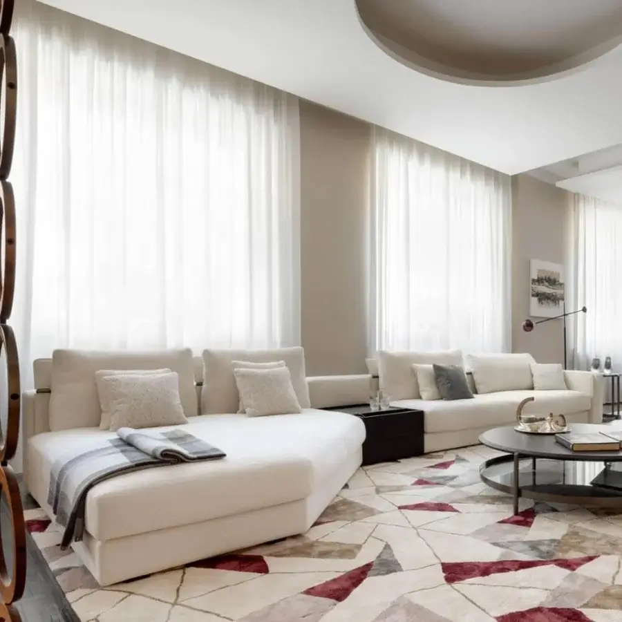 Superior Giorgetti Skyline sectional upholstered in light cream textile with reclining headrests and plush goose feather cushions