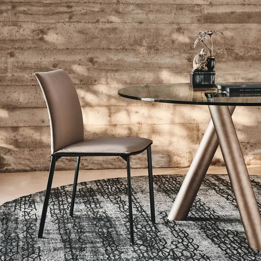Elegant Cattelan Italia Rita chair with black painted steel frame and light brown textile upholstery showcasing a curved backrest