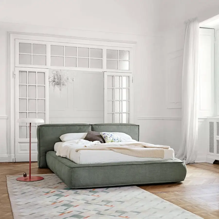 Superior Bonaldo Fluff bed with rounded design upholstered in muted green textile exhibiting a matte finish