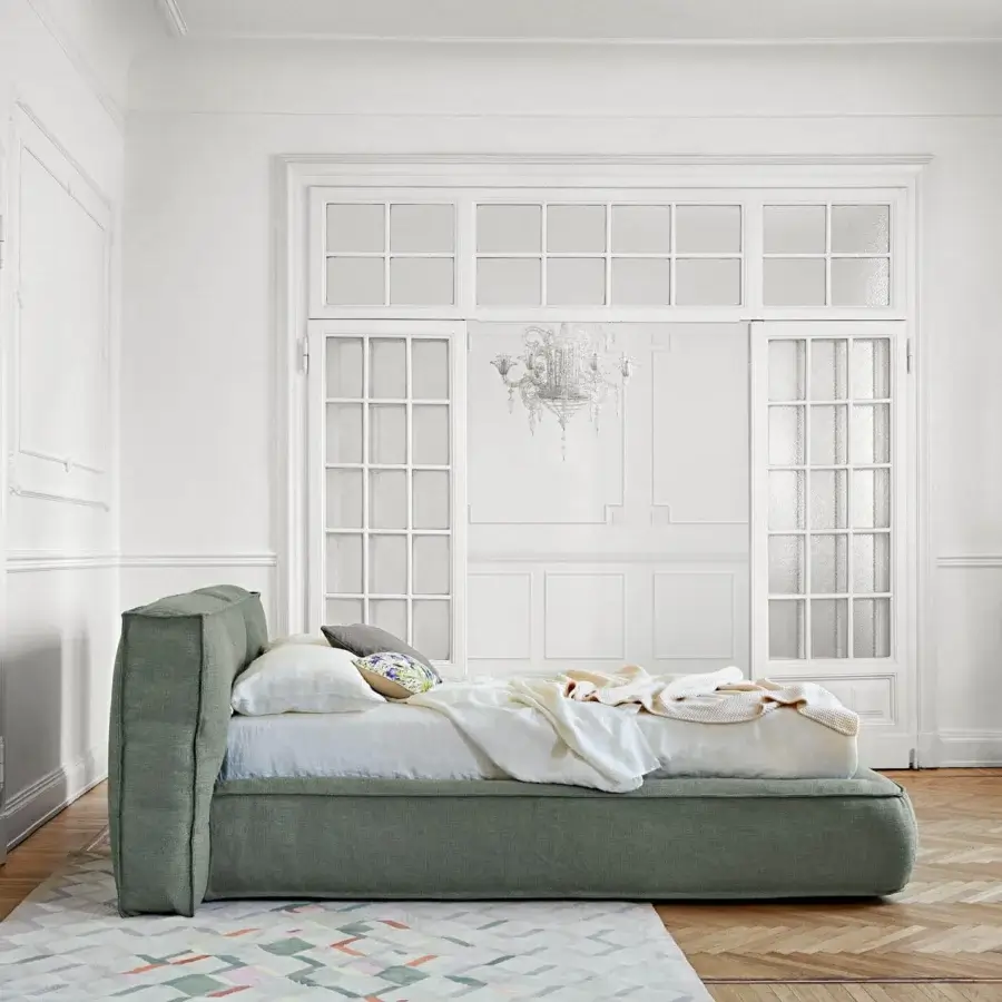 Elegant Bonaldo Fluff bed with soft rounded design upholstered in light green woven textile exhibiting a fully removable cover