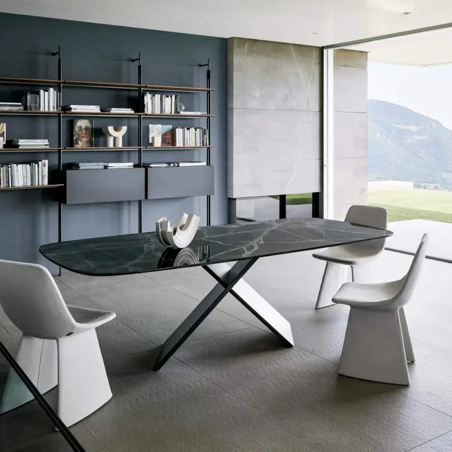 Elegant Bonaldo AX table with shaped ceramic top exhibiting subtle veining and glossy finish with painted metal X base