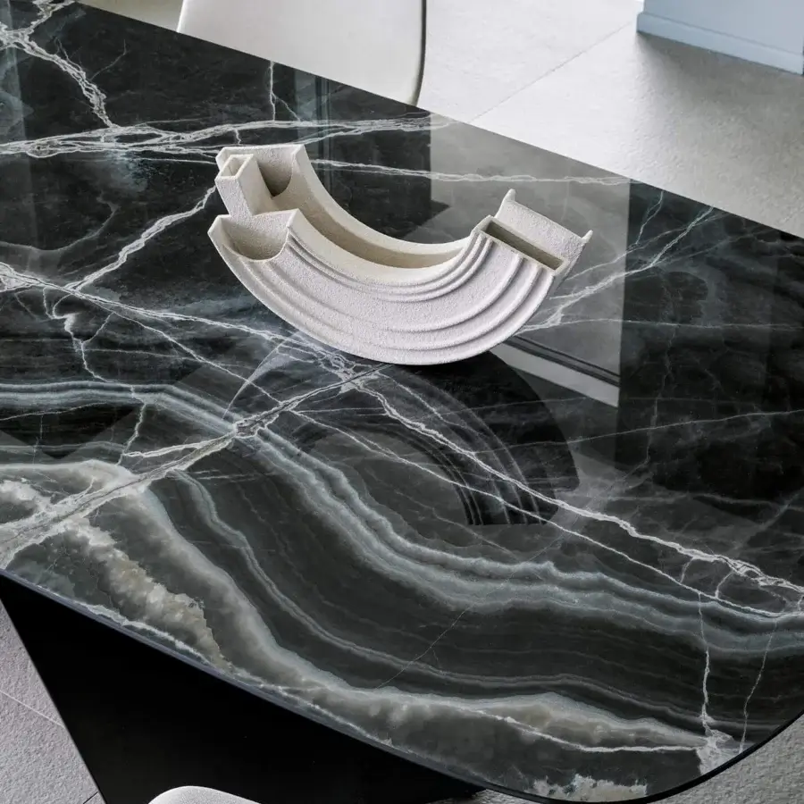 Captivating Bonaldo AX table with glossy dark gray ceramic top exhibiting striking white veining and criss-crossed metal base in a dark finish